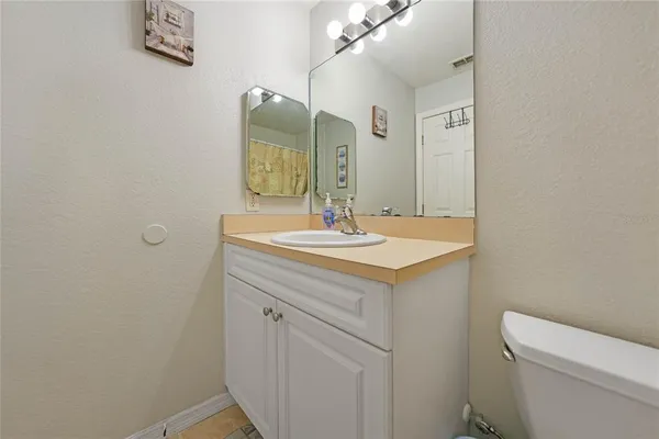 a bathroom with a sink a toilet and mirror