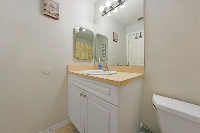a bathroom with a sink a toilet and mirror