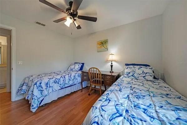 a bedroom with bed and a chandelier