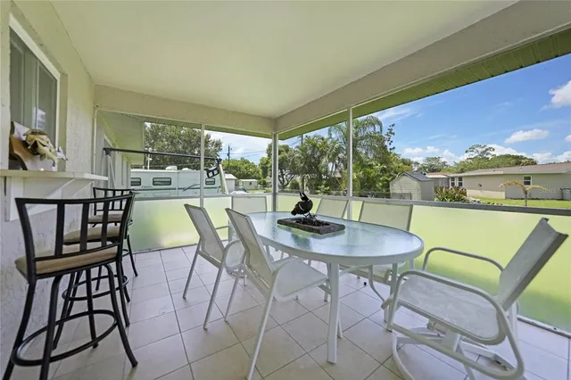 a dining room with furniture and a floor to ceiling window