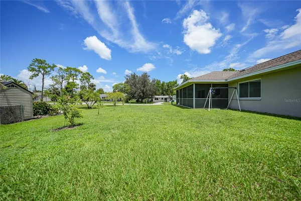 a view of a house with a backyard
