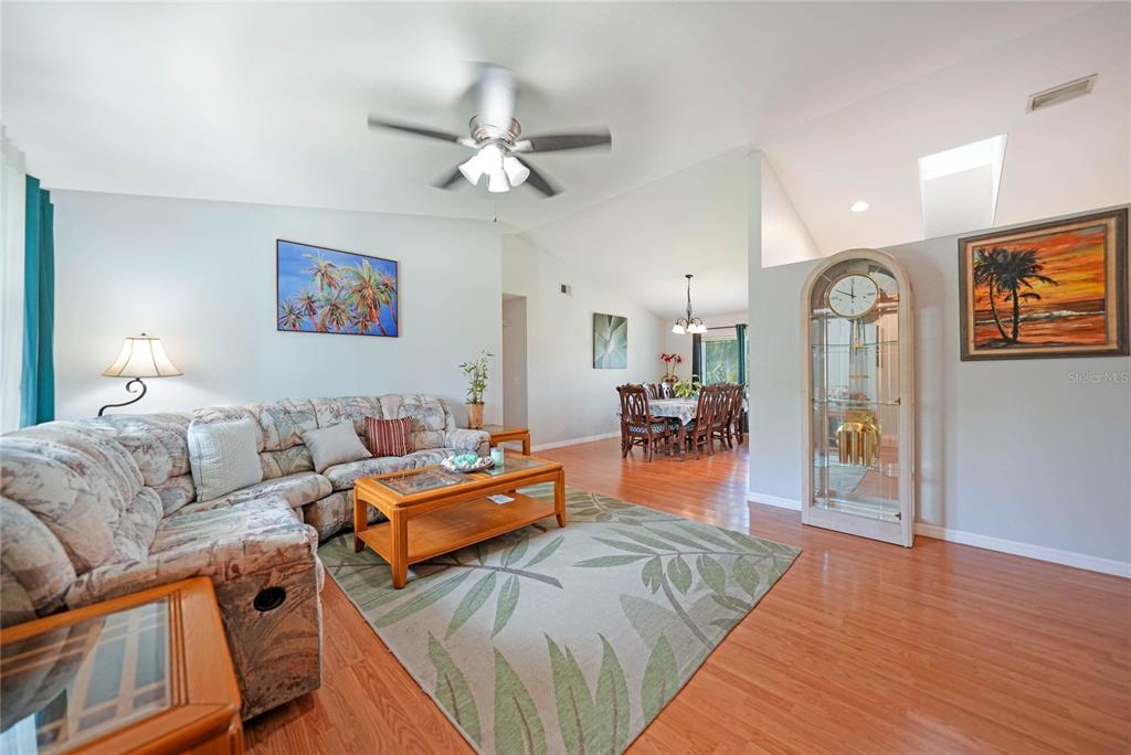590 Ridgewood Street Northwest Port Charlotte, FL 33952 - Photo 5 of 32 a bedroom with furniture and a large mirror