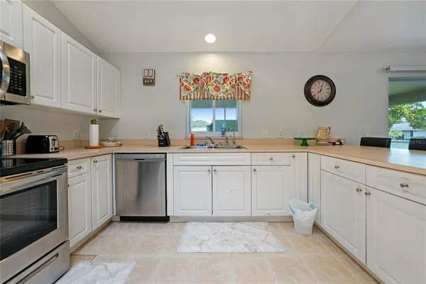 a kitchen with cabinets and window