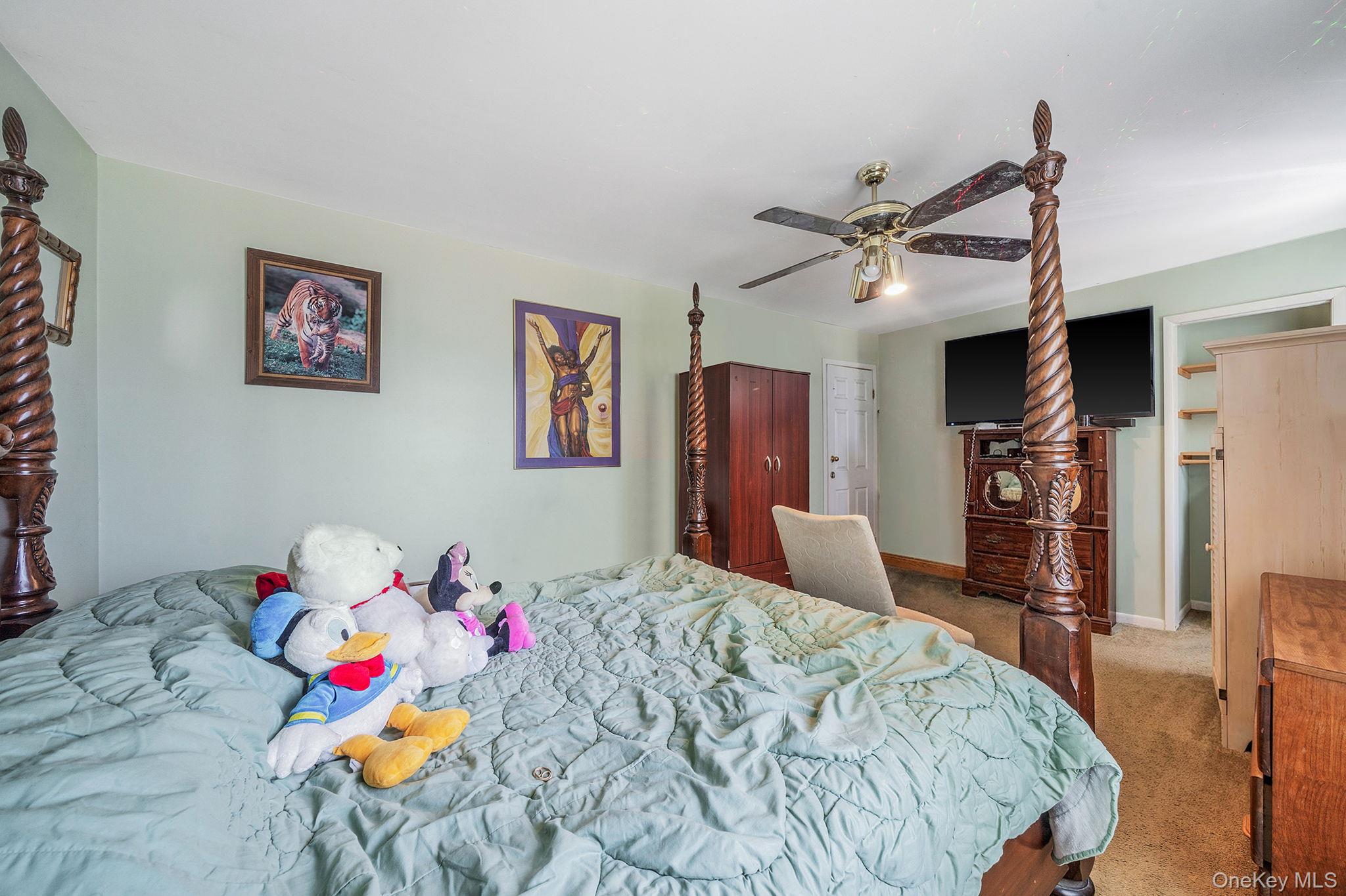 1169 Little E Neck Road West Babylon, NY 11704 - Photo 17 of 28 a bedroom that has a bed and a tv in it