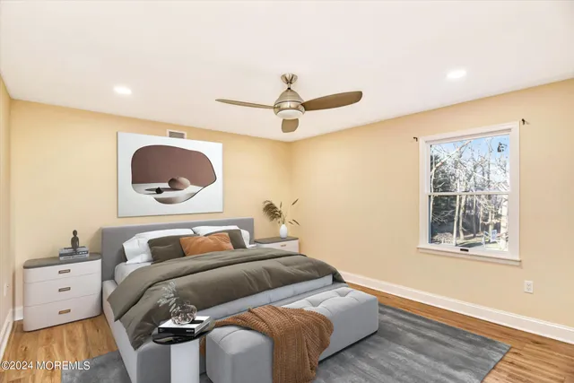 a bedroom with a large bed and a chandelier