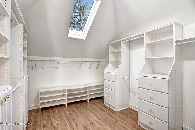 a view of walk in closet with empty racks