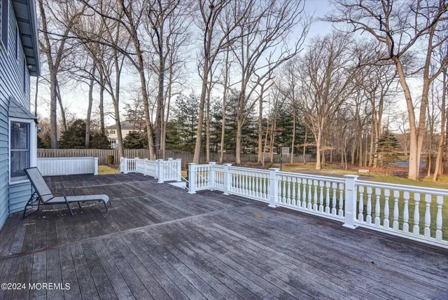 a view of a bench in a patio with wooden fence