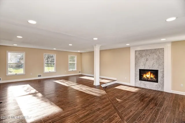 a view of empty room with a fireplace