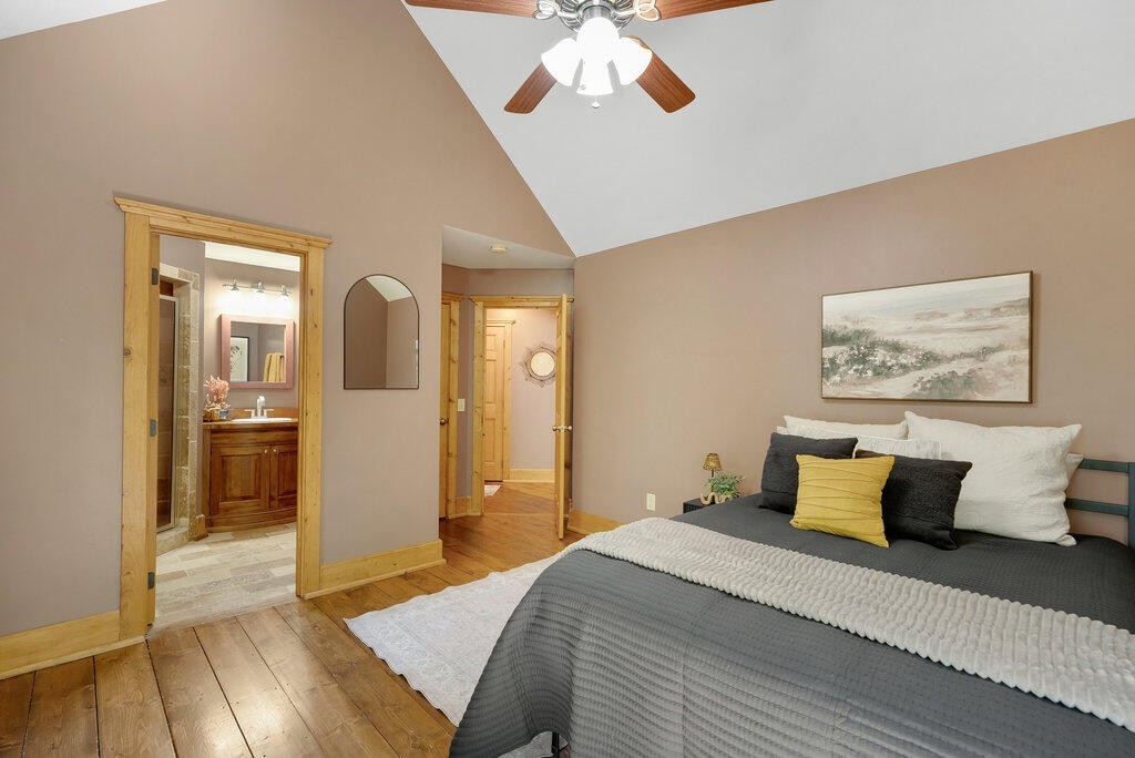 647 Omega Drive Spring City, TN 37381 - Photo 12 of 43 a bedroom with a bed and a chandelier