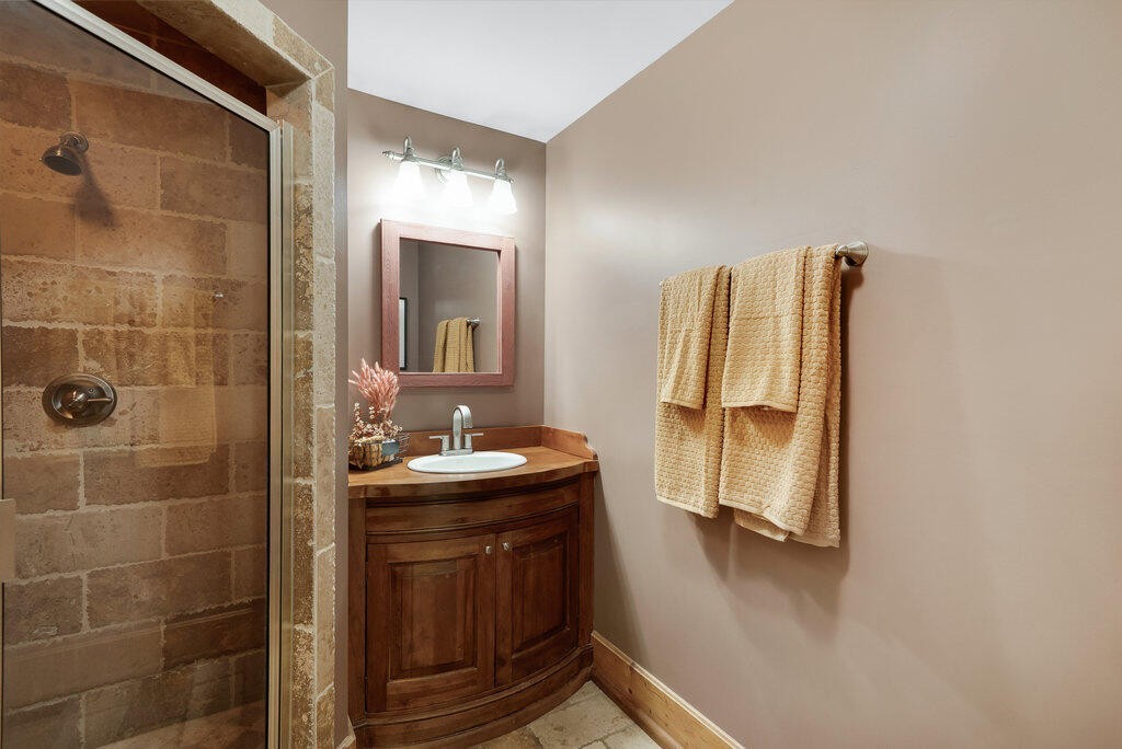 647 Omega Drive Spring City, TN 37381 - Photo 14 of 43 a bathroom with a sink a mirror and shower