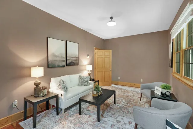 a living room with furniture and a potted plant