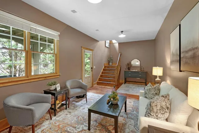 a living room with furniture and wooden floor