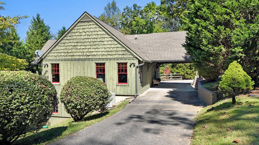 647 Omega Drive Spring City, TN 37381 - Photo 3 of 43 a view of a house with garden and plants