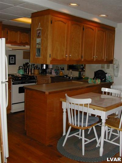 18 Hemlock Road Kunkletown, PA 18058 - Photo 16 of 37 a kitchen with a table chairs stove and cabinets