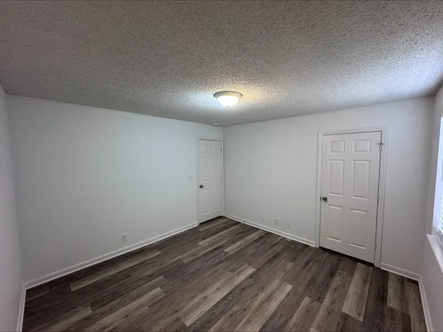 a view of room with wooden floor