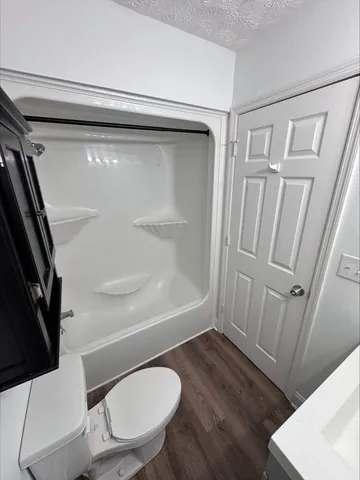 a bathroom with a toilet and a shower