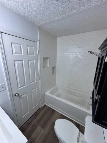 a bathroom with sink toilet and shower