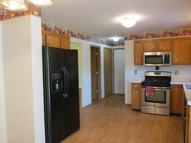 a view of a kitchen with a sink and a refrigerator