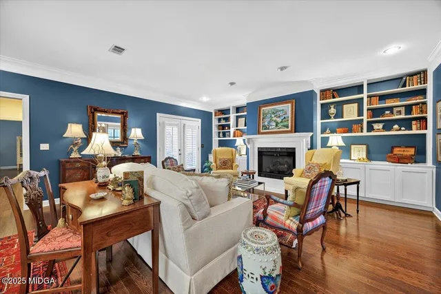 a living room with furniture a fireplace and a large window