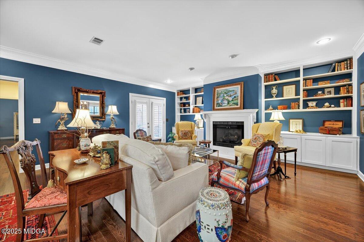 133 Covington Place Macon, GA 31210 - Photo 11 of 36 a living room with furniture a fireplace and a bookshelf