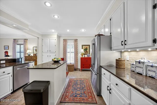 a kitchen with stainless steel appliances granite countertop a stove and cabinets