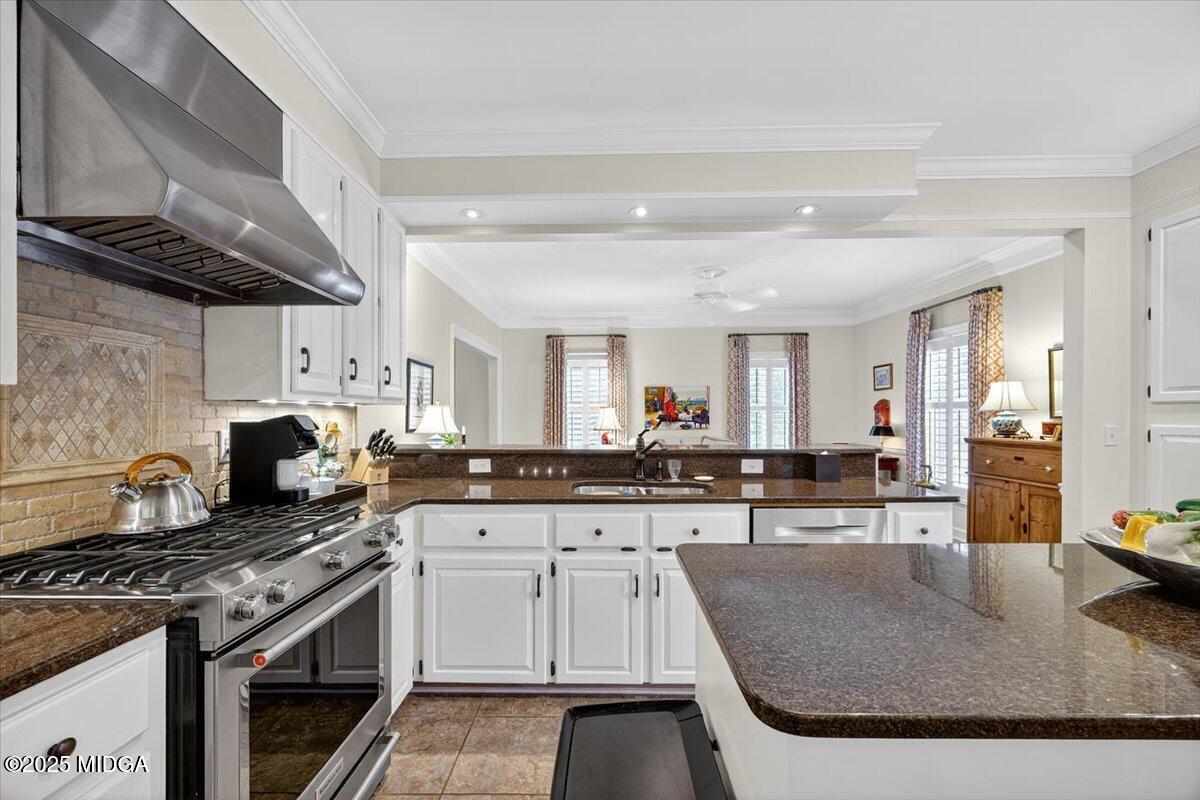 133 Covington Place Macon, GA 31210 - Photo 14 of 36 a kitchen with stainless steel appliances granite countertop a stove and cabinets