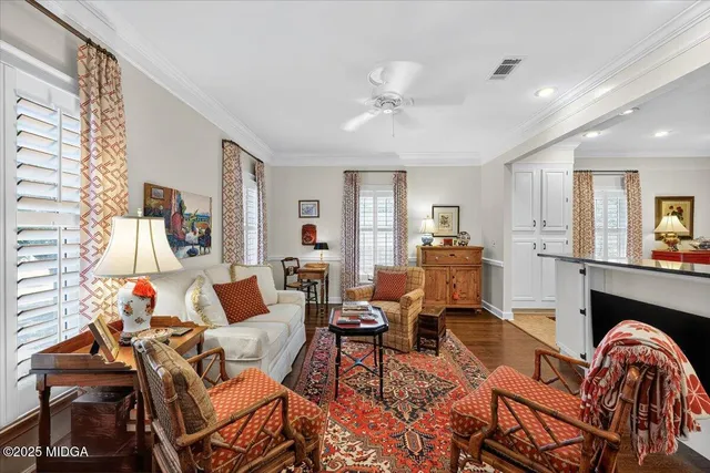 a living room with furniture and a wooden floor