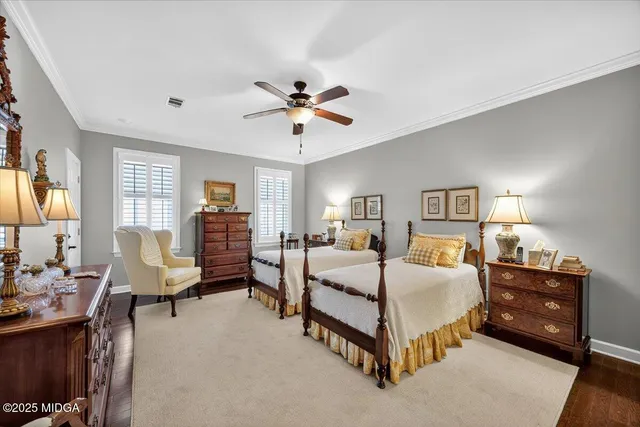 a bedroom with a bed couch and dresser