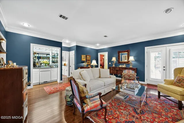 a living room with fireplace furniture and a wooden floor