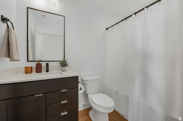 493 East Alice Way Layton, UT 84041 - Photo 22 of 31 Bathroom featuring curtained shower, vanity, and wood finished floors