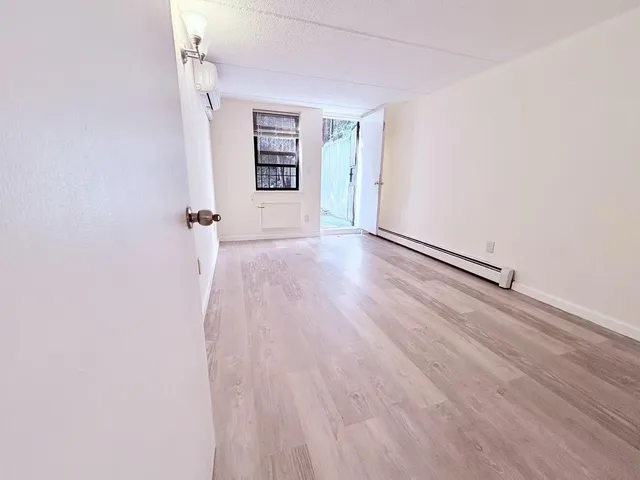 an empty room with windows and closet