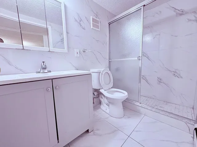 a white toilet sitting next to a bathroom sink