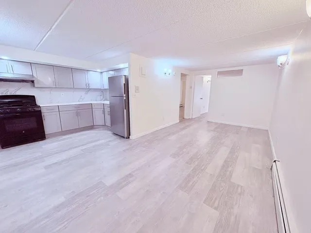 a view of a kitchen with a stove cabinets and wooden floor