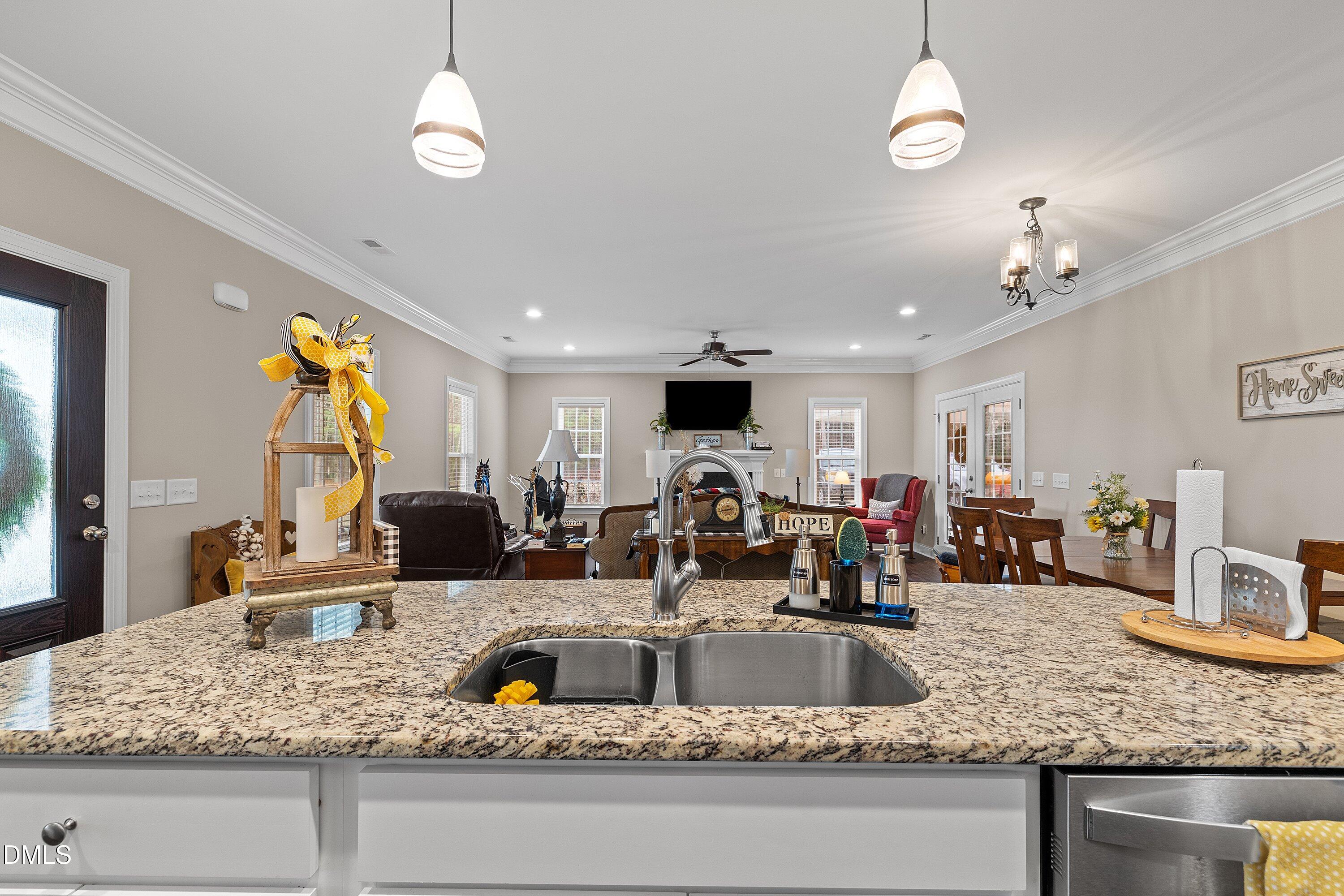 665 Mann Road Coats, NC 27521 - Photo 13 of 53 a kitchen with a counter top space cabinets and chandelier