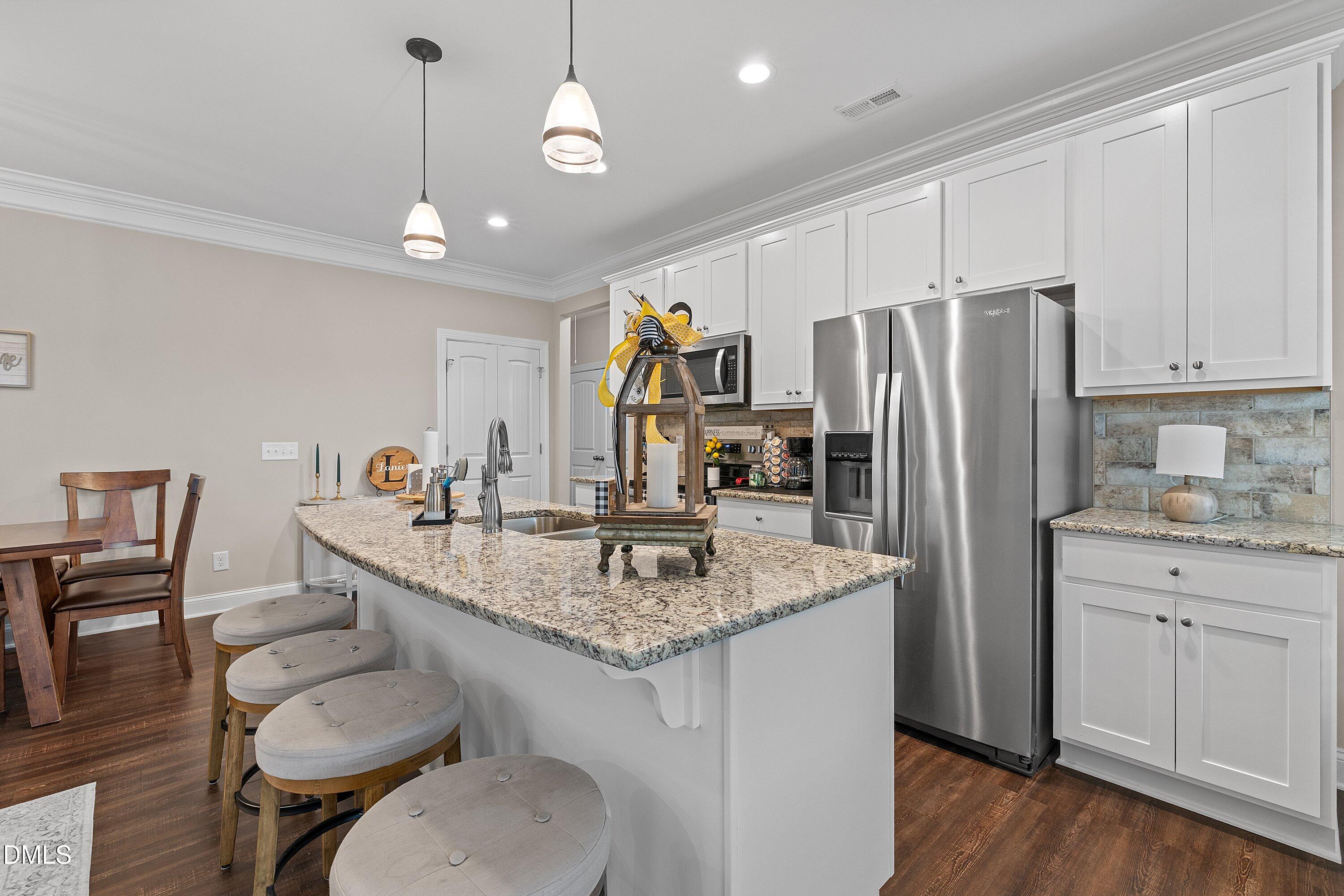 665 Mann Road Coats, NC 27521 - Photo 15 of 53 a kitchen with stainless steel appliances granite countertop a sink refrigerator and cabinets