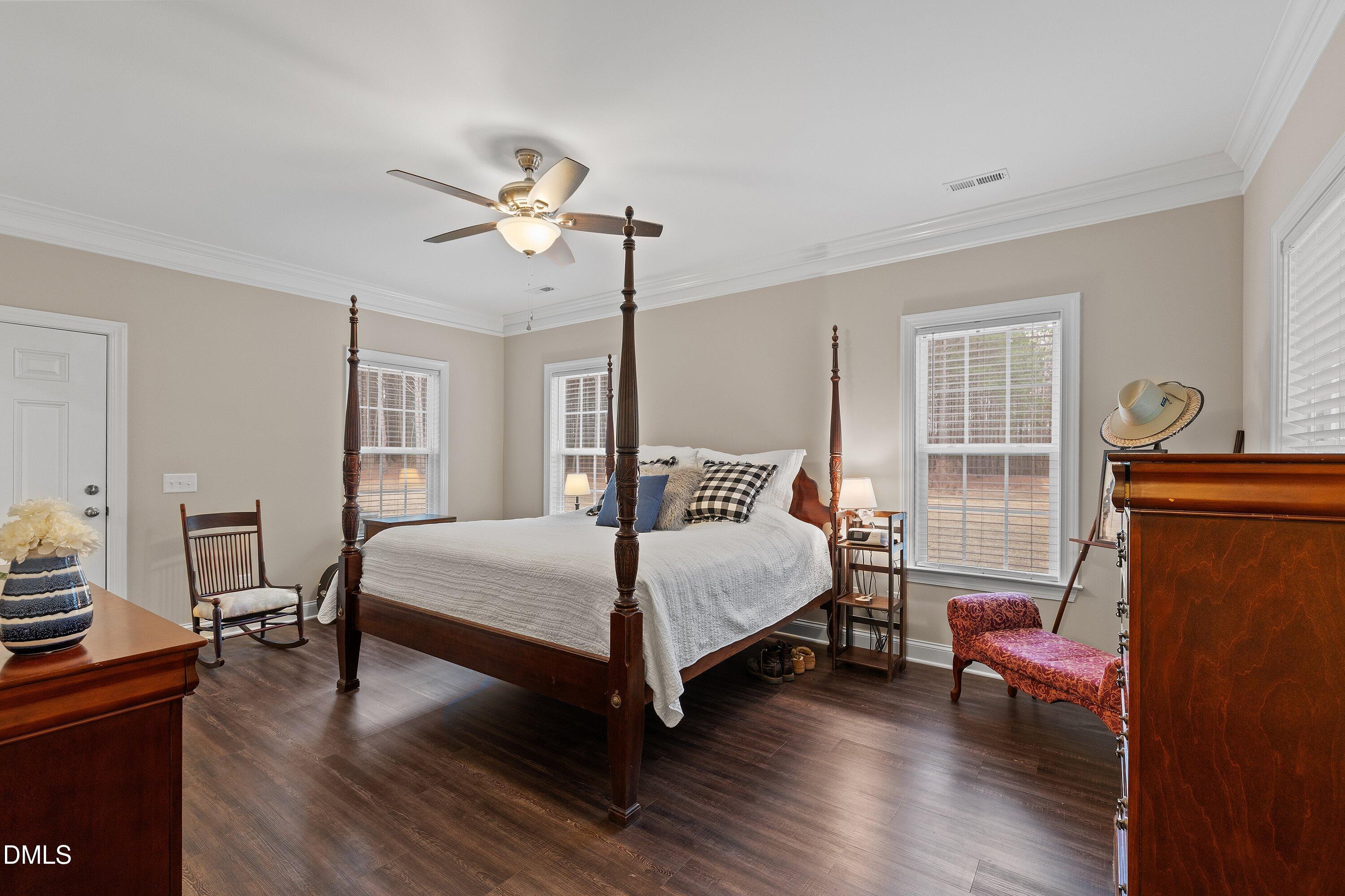 665 Mann Road Coats, NC 27521 - Photo 18 of 53 a bedroom with a bed a dresser and wooden floor