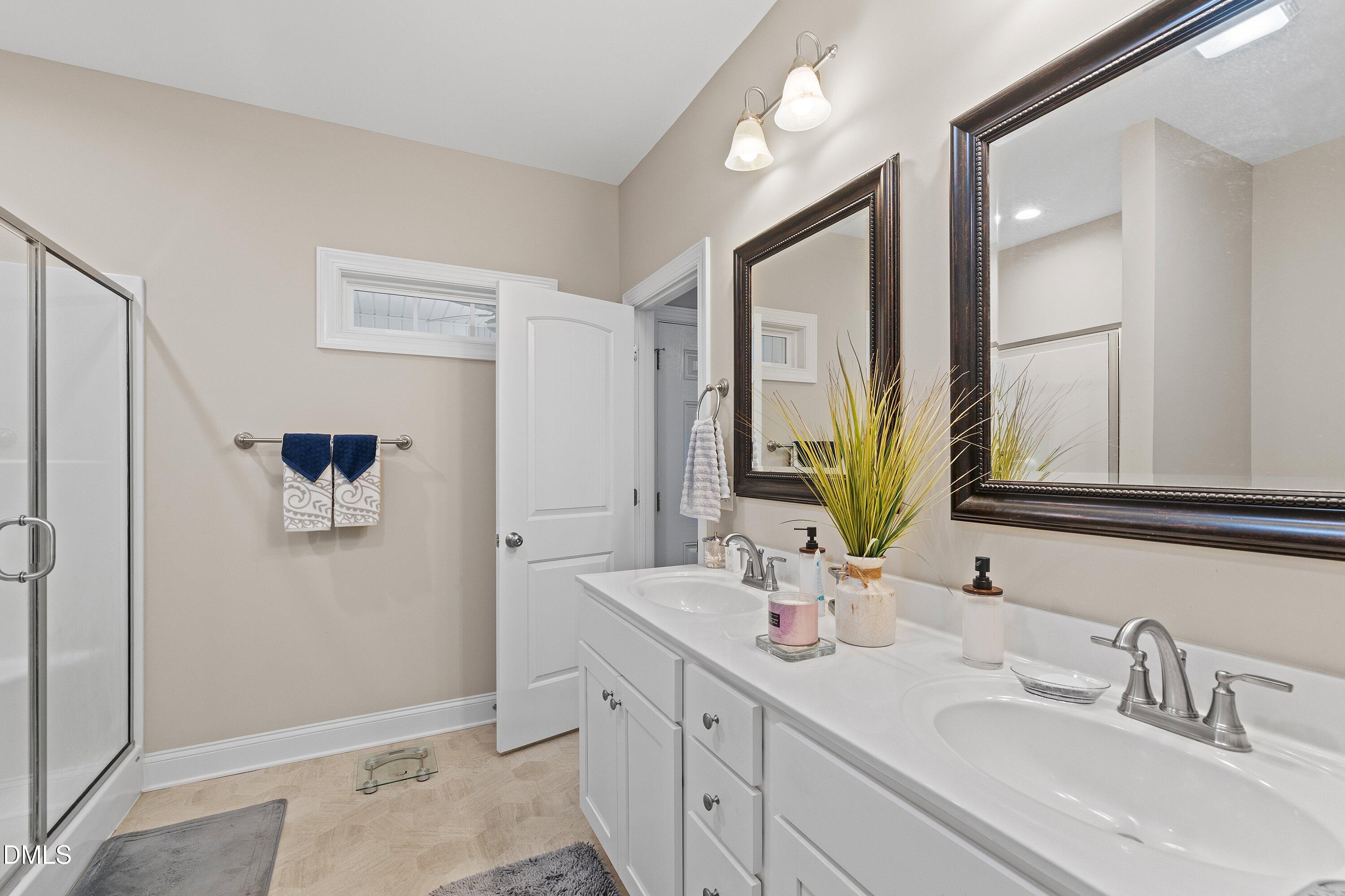 665 Mann Road Coats, NC 27521 - Photo 24 of 53 a bathroom with a double vanity sink mirror and
