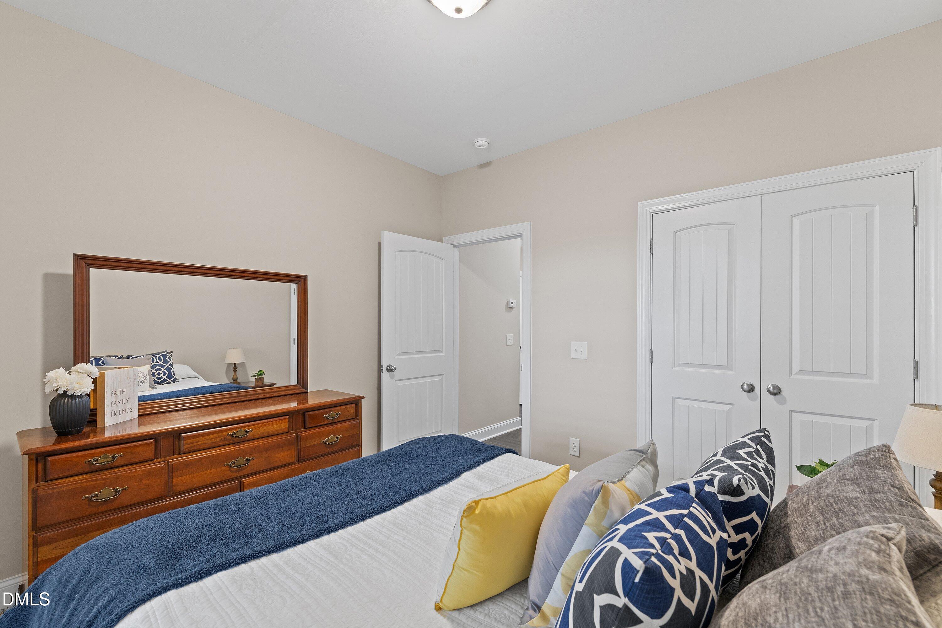 665 Mann Road Coats, NC 27521 - Photo 27 of 53 a bedroom with a bed and a dresser in it