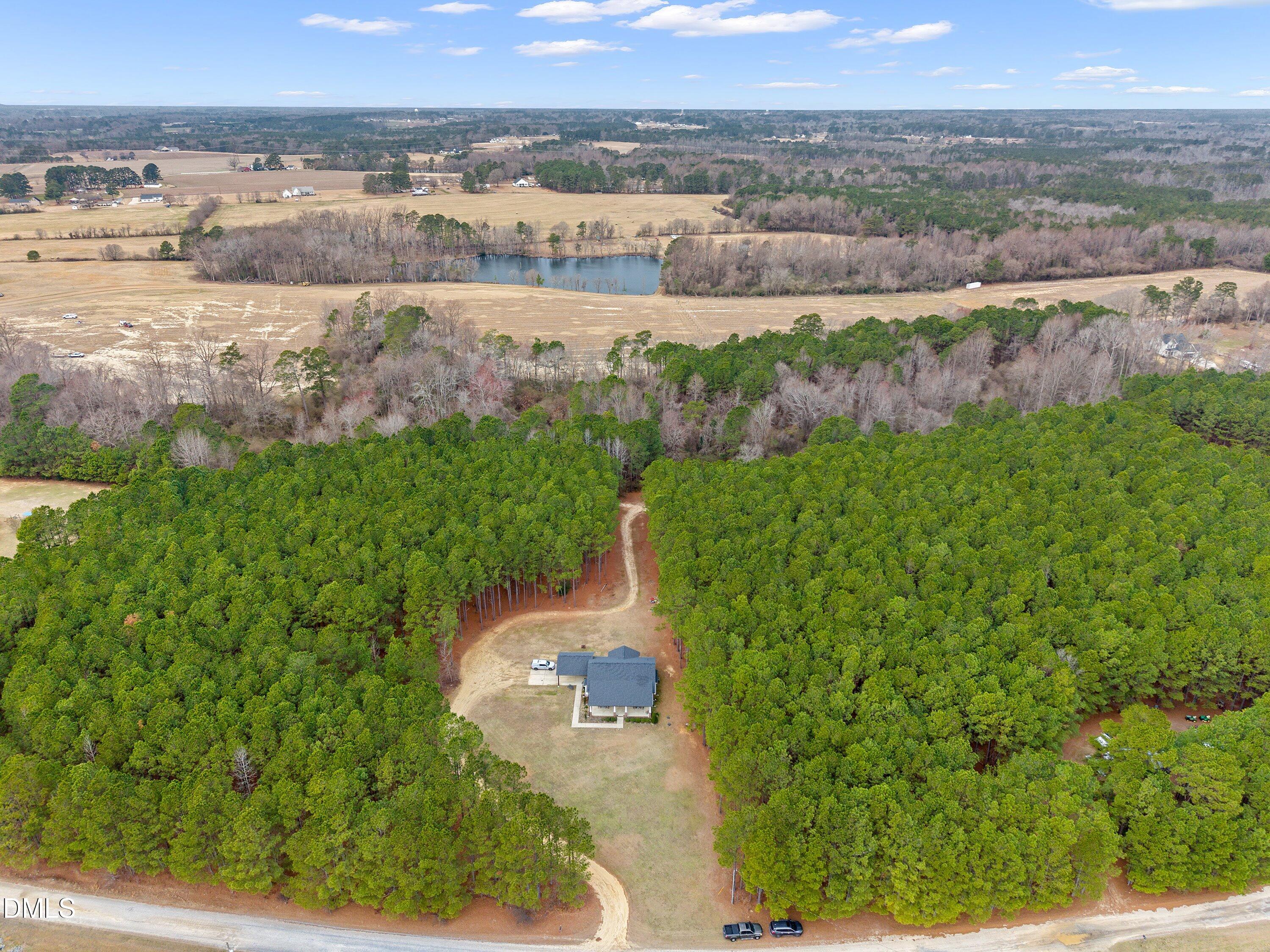 665 Mann Road Coats, NC 27521 - Photo 2 of 53 an aerial view of a houses with outdoor space and trees