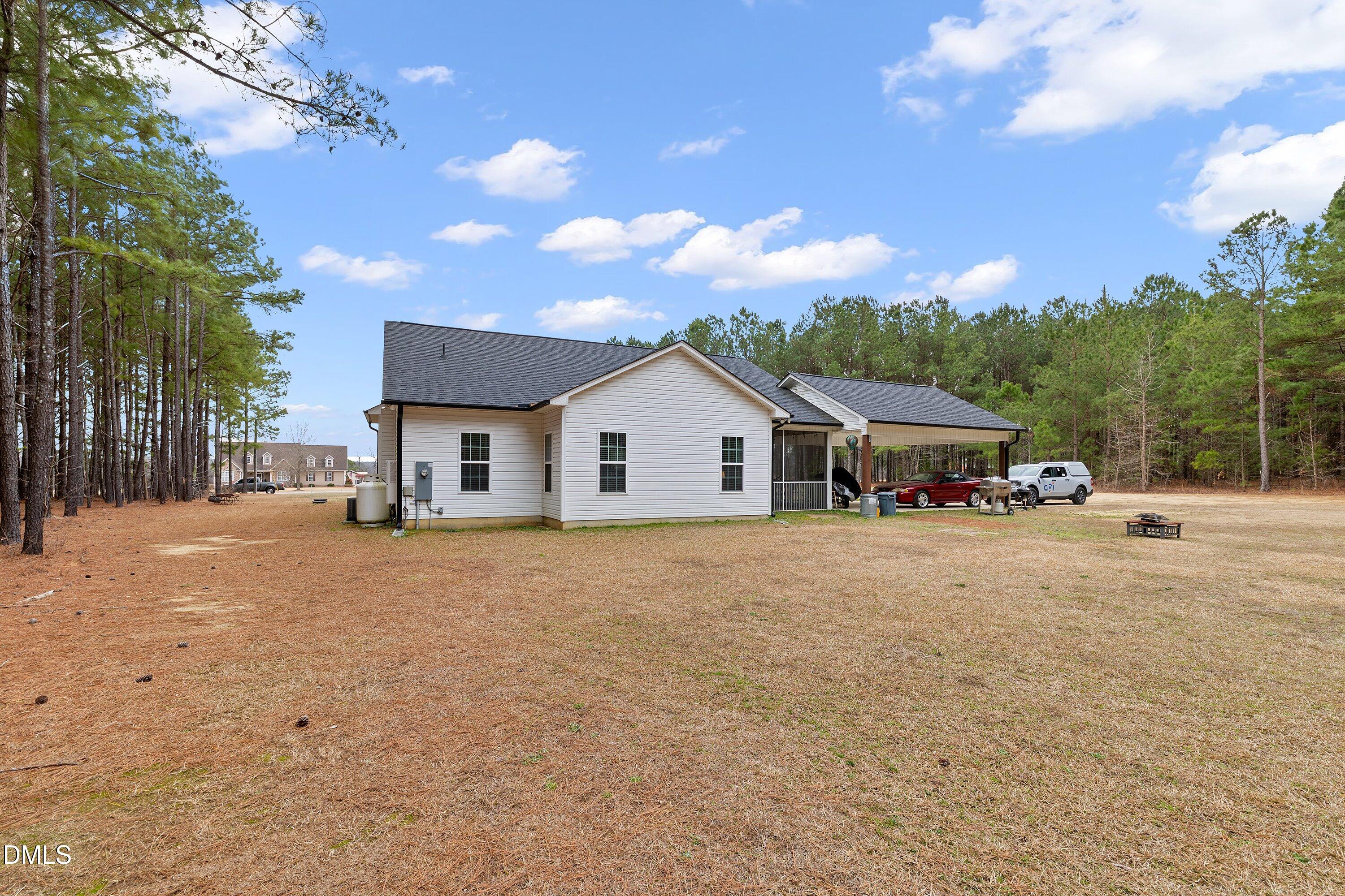 665 Mann Road Coats, NC 27521 - Photo 33 of 53 a big house with a big yard and large trees