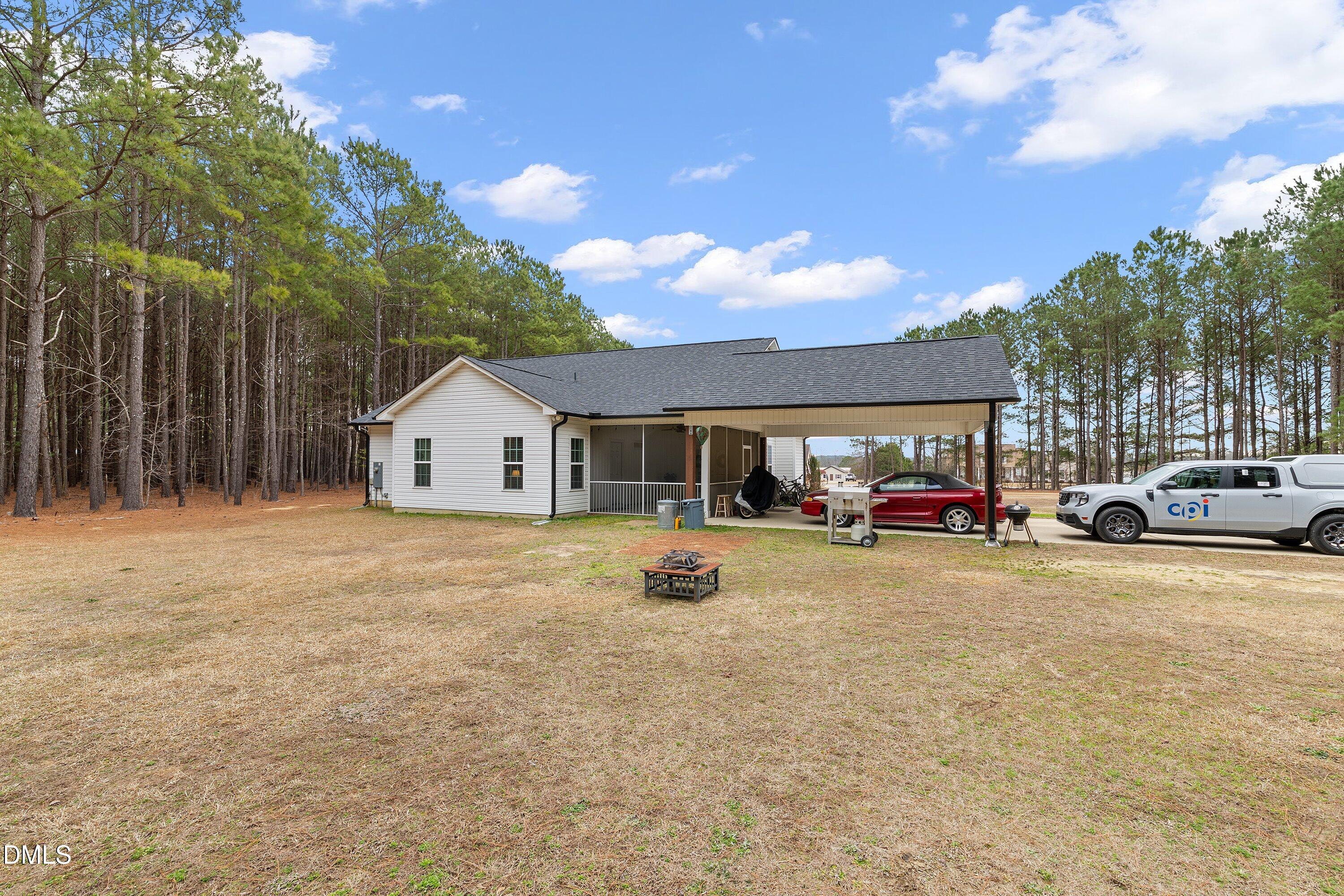 665 Mann Road Coats, NC 27521 - Photo 37 of 53 a view of a house with car parked