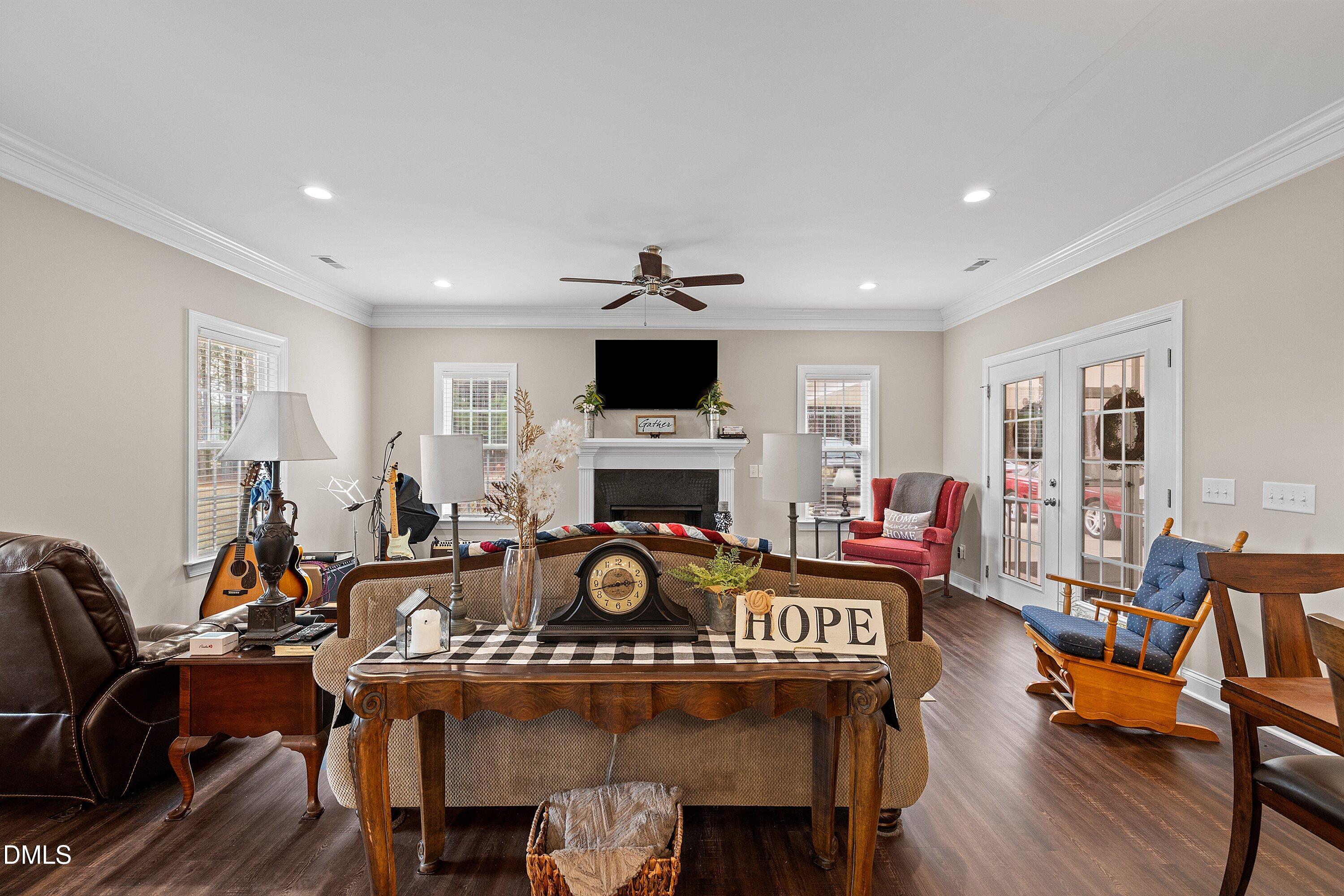 665 Mann Road Coats, NC 27521 - Photo 5 of 53 a living room with furniture a fireplace and a flat screen tv