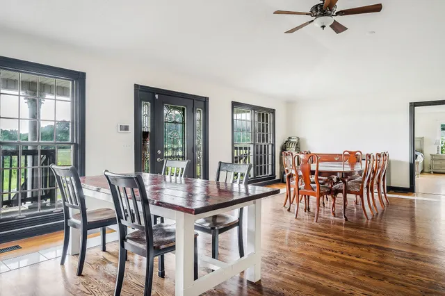 a dining room with furniture window and wooden floor