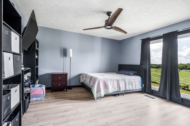 a spacious bedroom with a bed and large windows