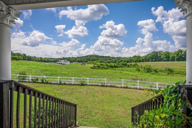 a building outdoor space with patio furniture and potted plants