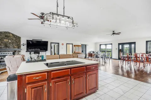a living room with furniture a flat screen tv and kitchen view