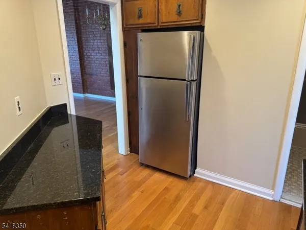 a view of a kitchen with wooden floor