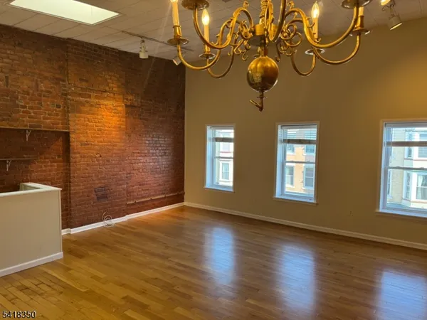 a view of a room with wooden floor and windows