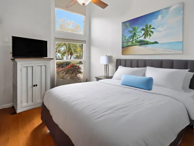 a bedroom with a bed and a flat screen tv