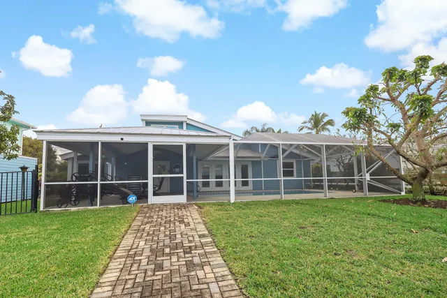 a view of a house with a yard and garden